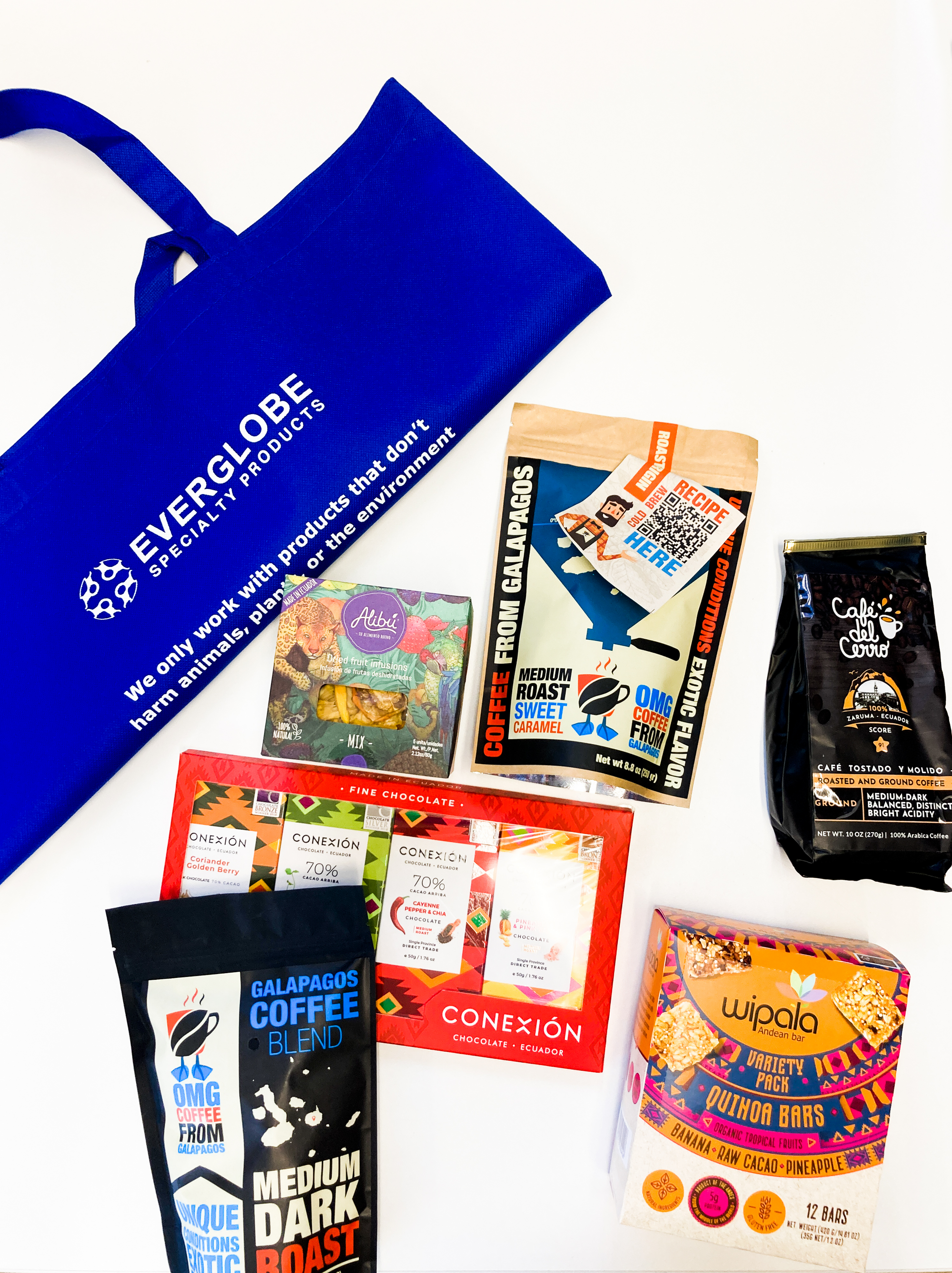 A flat lay image with all of Everglobe's specialty products on display with a tote bag folded in half on the upper left hand corner.